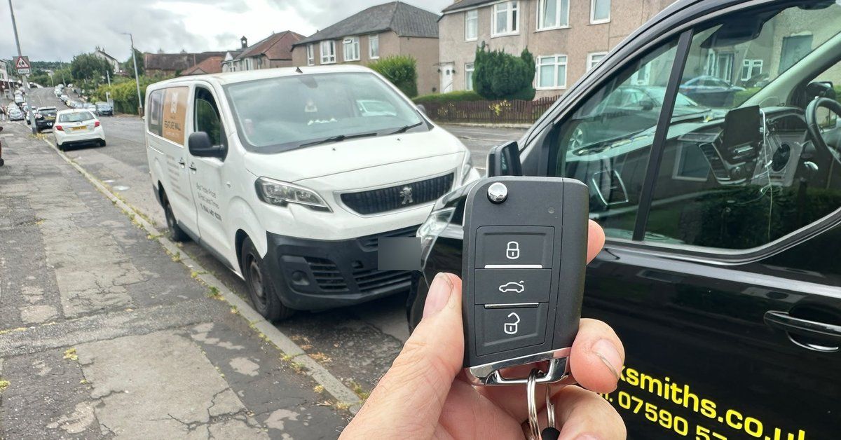 A new spare flip car key held beside the LKC Locksmiths van in Stirling